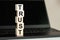 TRUST word made with building blocks on the black keyboard. A row of wooden cubes with a word written in black font is located on