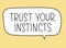 Trust your instincts inscription. Handwritten lettering illustration. Black vector text in speech bubble. Simple style