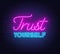 Trust yourself neon inspirational quote on a brick wall background.