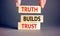 Truth builds trust symbol. Concept words Truth builds trust on wooden blocks on a beautiful grey table grey background.