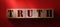 Truth word on wooden cubes on red. True or false facts, real and fake news concept
