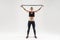 Trx equipment. Strong woman holding jumping rope near head