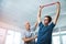 Try to relax your shoulders a bit. Low angle shot of a handsome mature male physiotherapist helping a patient stretch