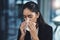 Trying her best to keep the sniffles at bay. a young businesswoman blowing her nose in an office.