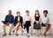 Trying not to let the boredom get to them. Shot of a group of businesspeople seated in line while waiting to be