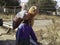 Trying to earn a living in poor town a woman carries bags of snacks on her head hoping to find a buyer in Soweto South Africa -