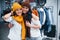 Trying warm hats and scarfs. Two young women have a shopping day together in the supermarket