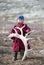 Tsaatan boy, dressed in a traditional deel with a reindeer horn