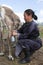 Tsaatan woman milks reindeer in northern Mongolia