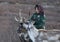 Tsaatan woman with reindeer in Northern Mongolian landscape