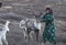 Tsaatan woman with reindeer in Northern Mongolian landscape