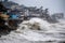 tsunami hits shoreline with massive wave, flooding the beach and nearby structures