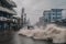 tsunami wave crashes into coastal city, flooding streets and destroying buildings