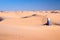 Tuareg man sitting in the Sand dunes desert of Sahara