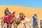 Tuareg men promenade with dromedaries