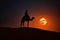 Tuareg riding a camel in desert at night with red full supermoon in the background. Generative Ai