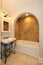 Tub with arch and stone tiles sink bathroom