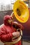 Tuba player marching under rain at Carnival parade, Stuttgart