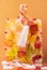 A tube of cosmetics frozen with autumn leaves and a bunch of mountain ash