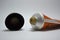 A tube of orange cream with a black plastic cap is located on a white background. Cream for face and neck skin care, skin hydratio