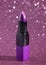Tube of Purple Lipstick on a Bright Pink Glittery Background