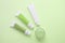 tubes with cosmetic creams, one jar with cosmetics on a green background, beauty concept