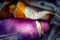 Tubes of paint open and extruded orange and violet th color, blurred background