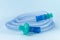 Tubing for CPAP or BIPAP machine with green filter isolated on blue background.