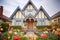 tudor with front gable framed by flowering shrubs