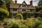 tudor house surrounded by greenery and flowers