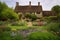 tudor house, surrounded by picturesque garden, with blooming flowers and shrubbery