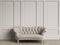 Tufted ivory color sofa in classic interior with copy space