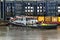 Tug alongside pier on River Thames UK