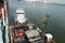 Tug boat and bunker barge with valves and manifolds observed from the container vessel which is alongside.