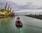 tug boat mooving a big ship inside marghera harbour