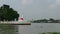 A tug boat passes in front of iconic chedi