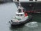 A tug boat pulling a large container ship in Durban Harbour South Africa