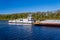 Tug boat pusher behind freight barges loaded with grain on Mississippi River