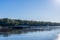 Tug boat pusher behind freight barges loaded with grain on Mississippi River