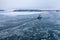 Tug boat pushing through the ice on a sea in winter