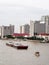 Tug boat service on CHAO PHRAYA river BANGKOK, THAILAND pulling heavy floating container