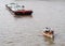 Tug boat service on CHAO PHRAYA river BANGKOK, THAILAND pulling heavy floating container