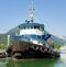 A tug-boat tied alongside a dock in alaska