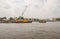 Tug boats with a cargo ship on the Chao Phraya River in Bangkok