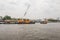 Tug boats with a cargo ship on the Chao Phraya River in Bangkok