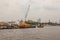 Tug boats with a cargo ship on the Chao Phraya River in Bangkok