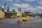 A tug pulling a container barge up the river thames