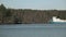 A tug pushes a barge along the river early in the morning.