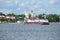 The tug Rechnoy 76 with a barge against the city\'s historic centre. Ferry in the city of Myshkin. Yaroslavl regio