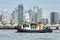 Tugboat assist cargo ship in the city